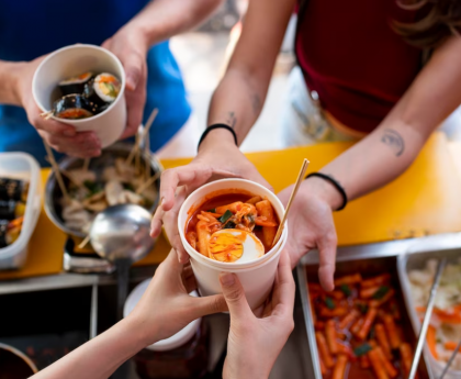 hands holding cup with food