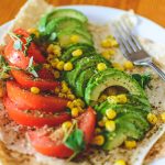 Sliced Tomato and Avocado on White Plate