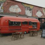 A Red Food Truck on a Brick Pavement